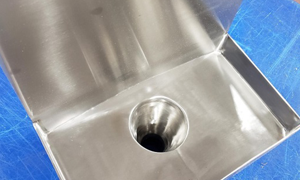 Custom square to round sink with a 1-inch drop. The flange was welded and blended smooth. Notice the square to round section one piece. Image provided by Nick Martin